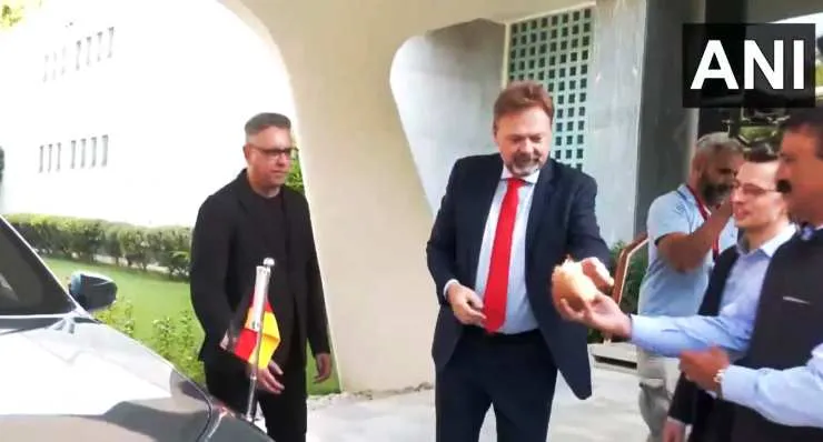 German-Embassador-to-India-also-breaks-coconut-infront-of-his-BMW-i7