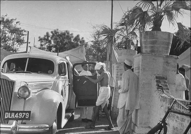 Gandhi entering a Packard 120